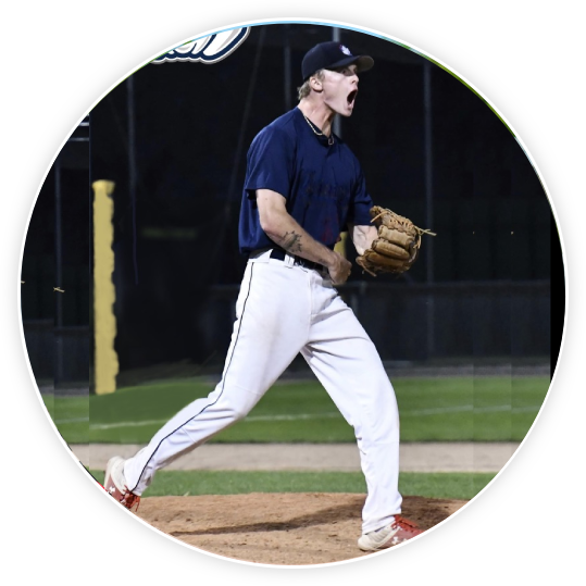 A man on the field wearing a glove and shouting